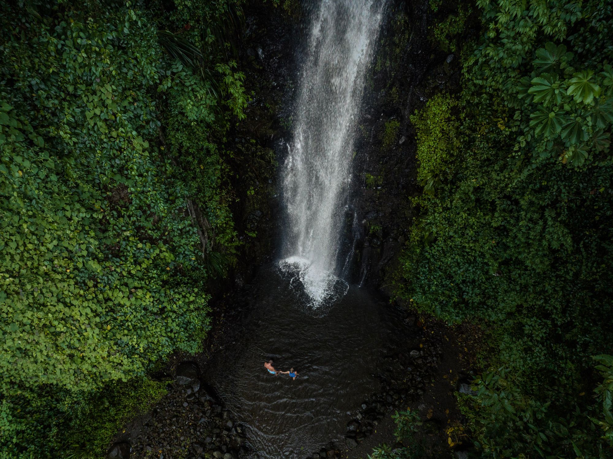 couple swimming at dark view falls
