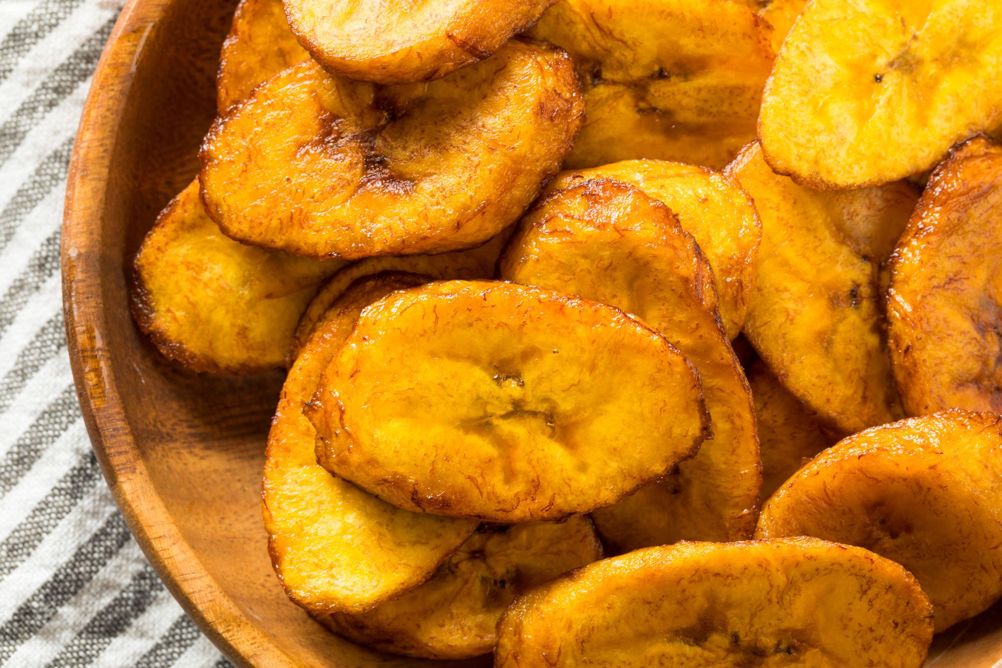 fried plantains on a wooden plate