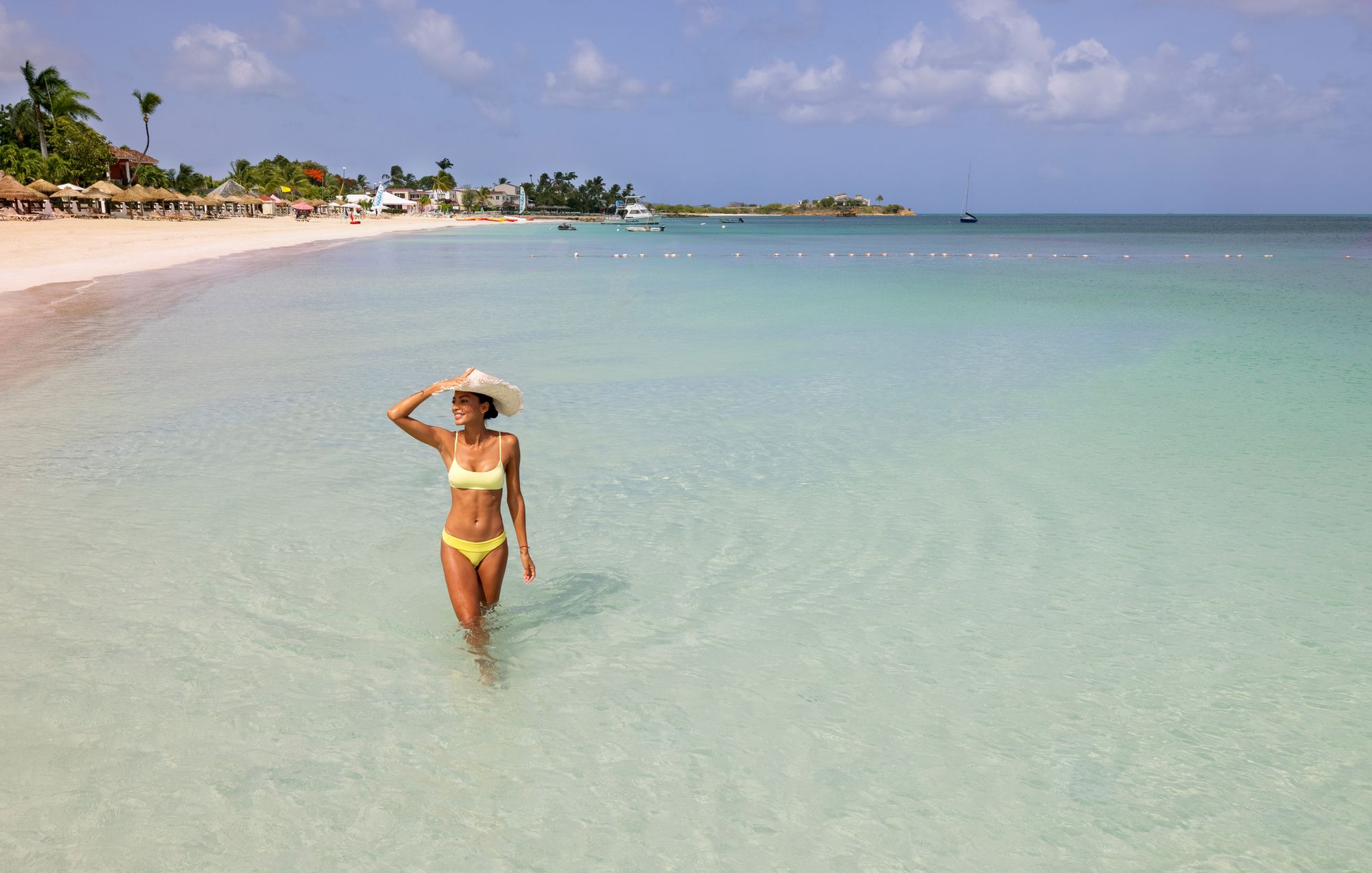 woman on Dickenson Bay beach in Antigua