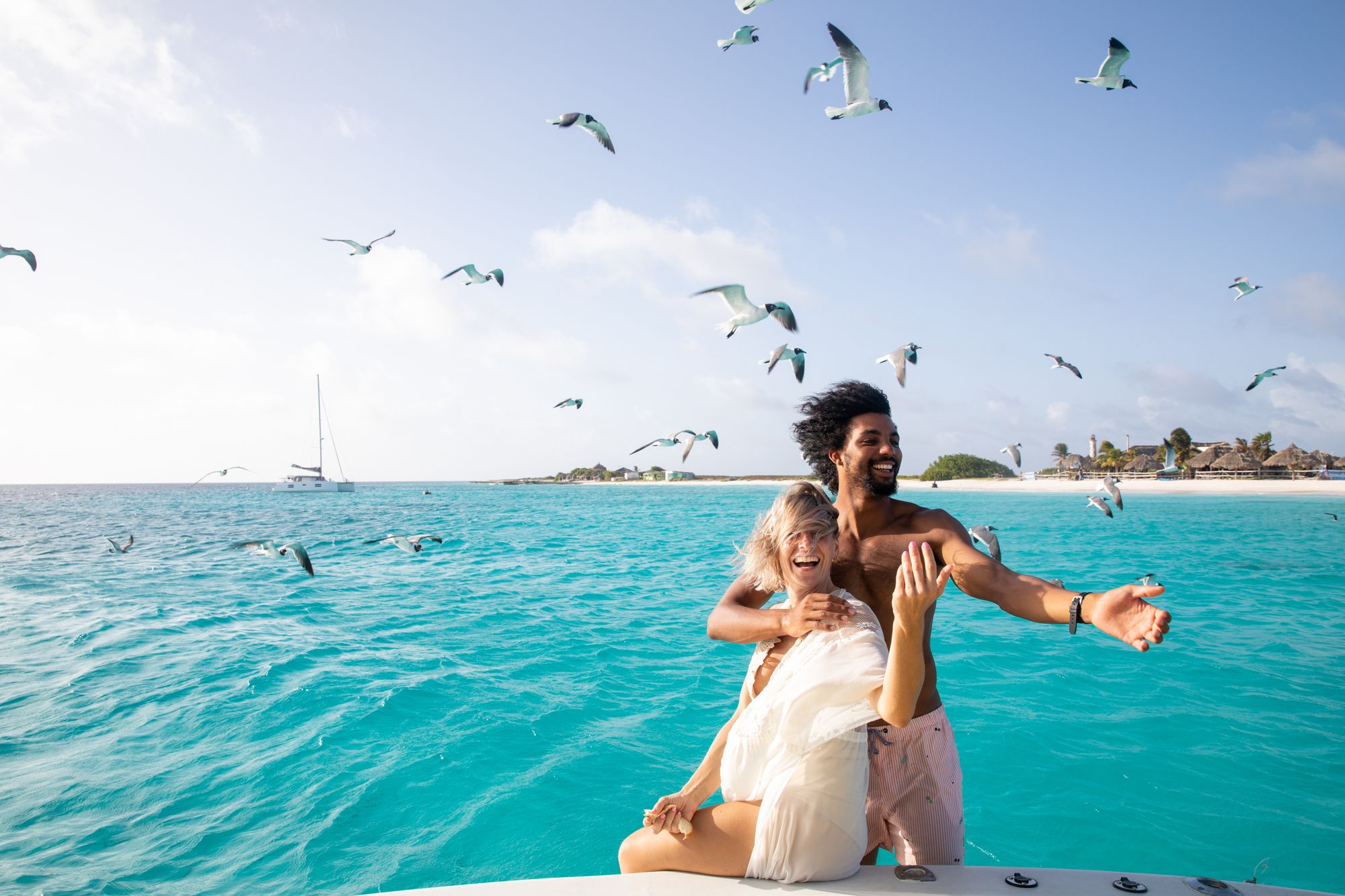 couple on boat with birds