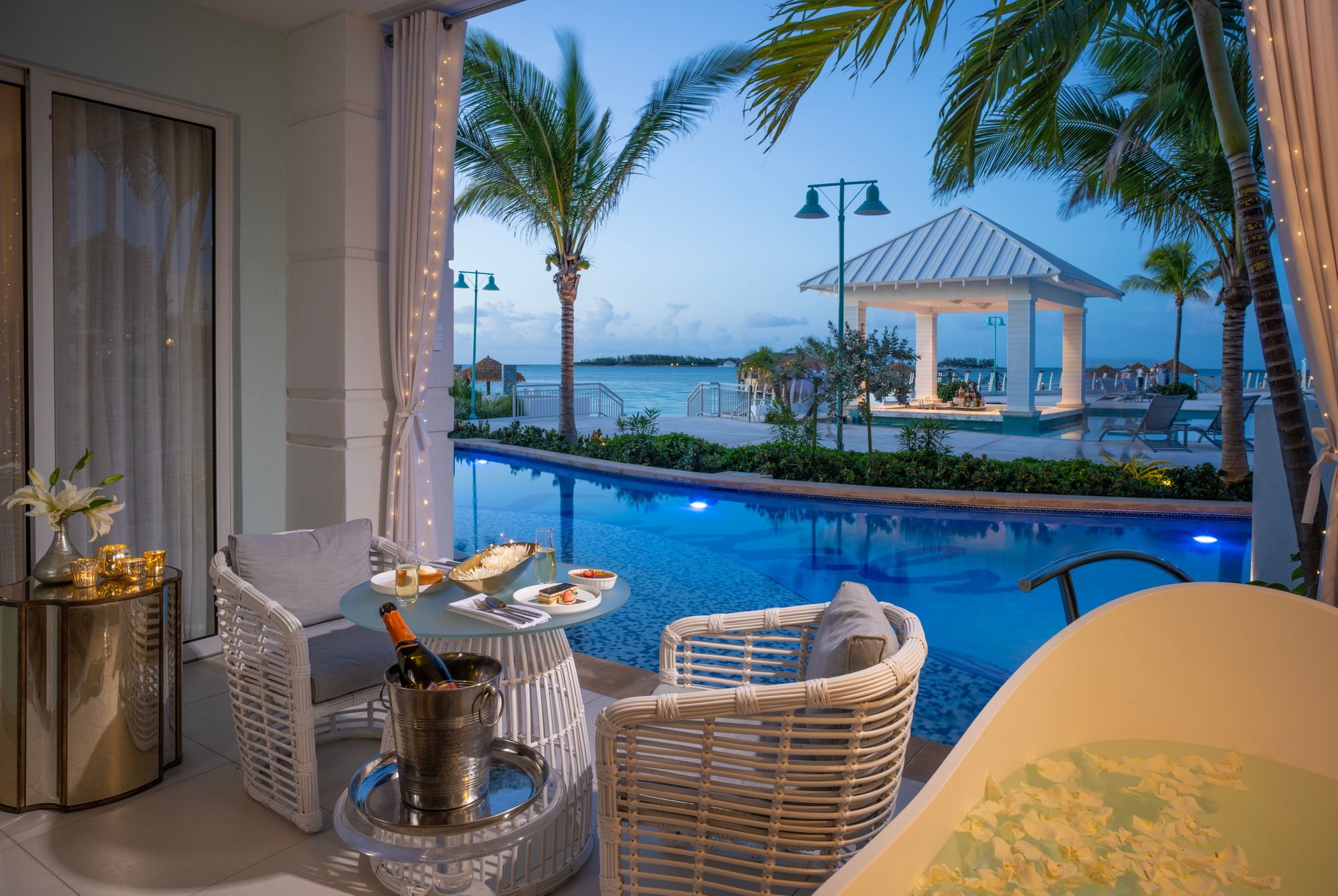SRB---OS1B---West-Bay-One-Bedroom-Oceanview-Swim-up-Butler-Suite-with-Patio-Tranquility-Soaking-Tub---Patio-Night