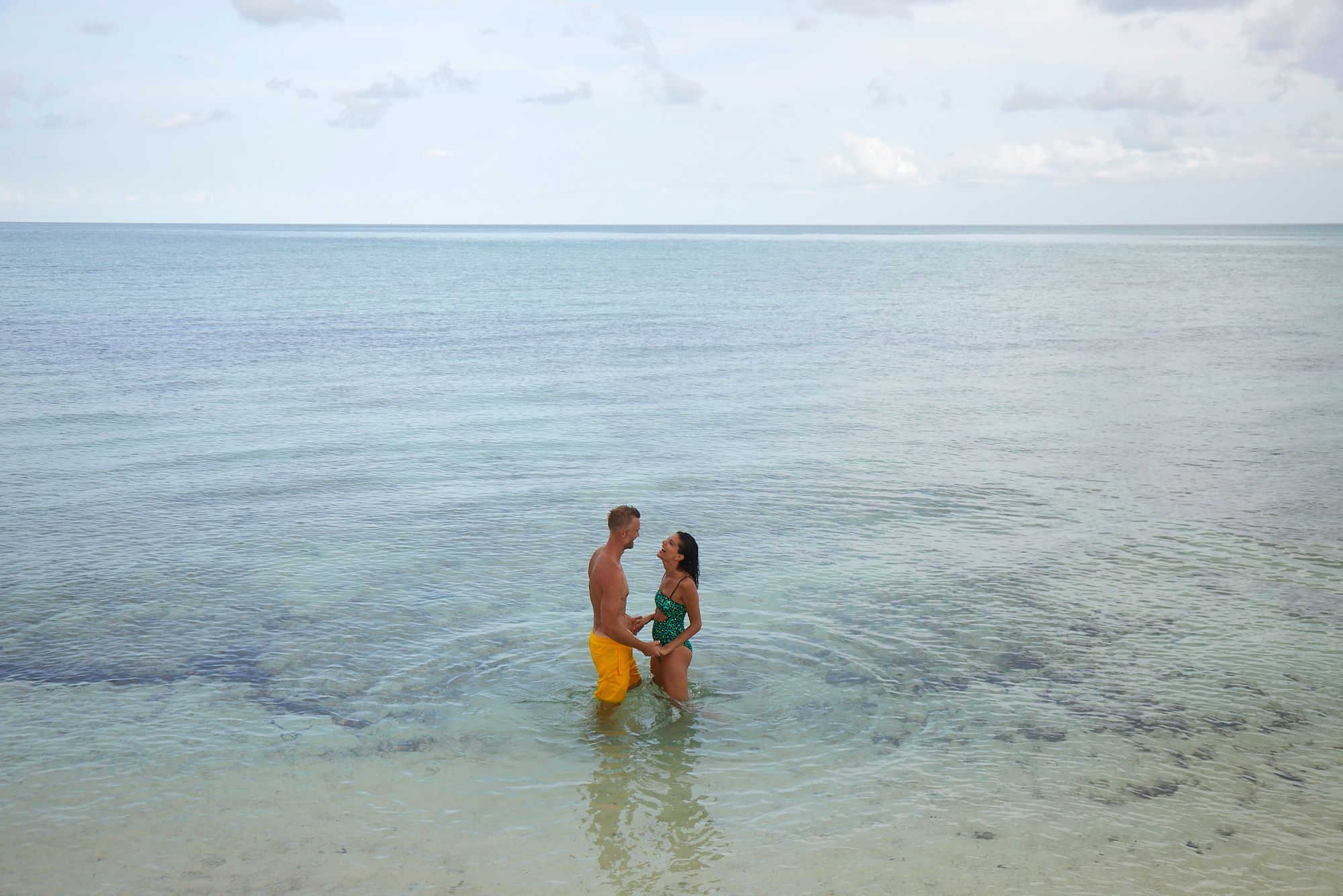 SRB-Lifestyle-Couple-Holding-Hands-Shallow-Water-1-1