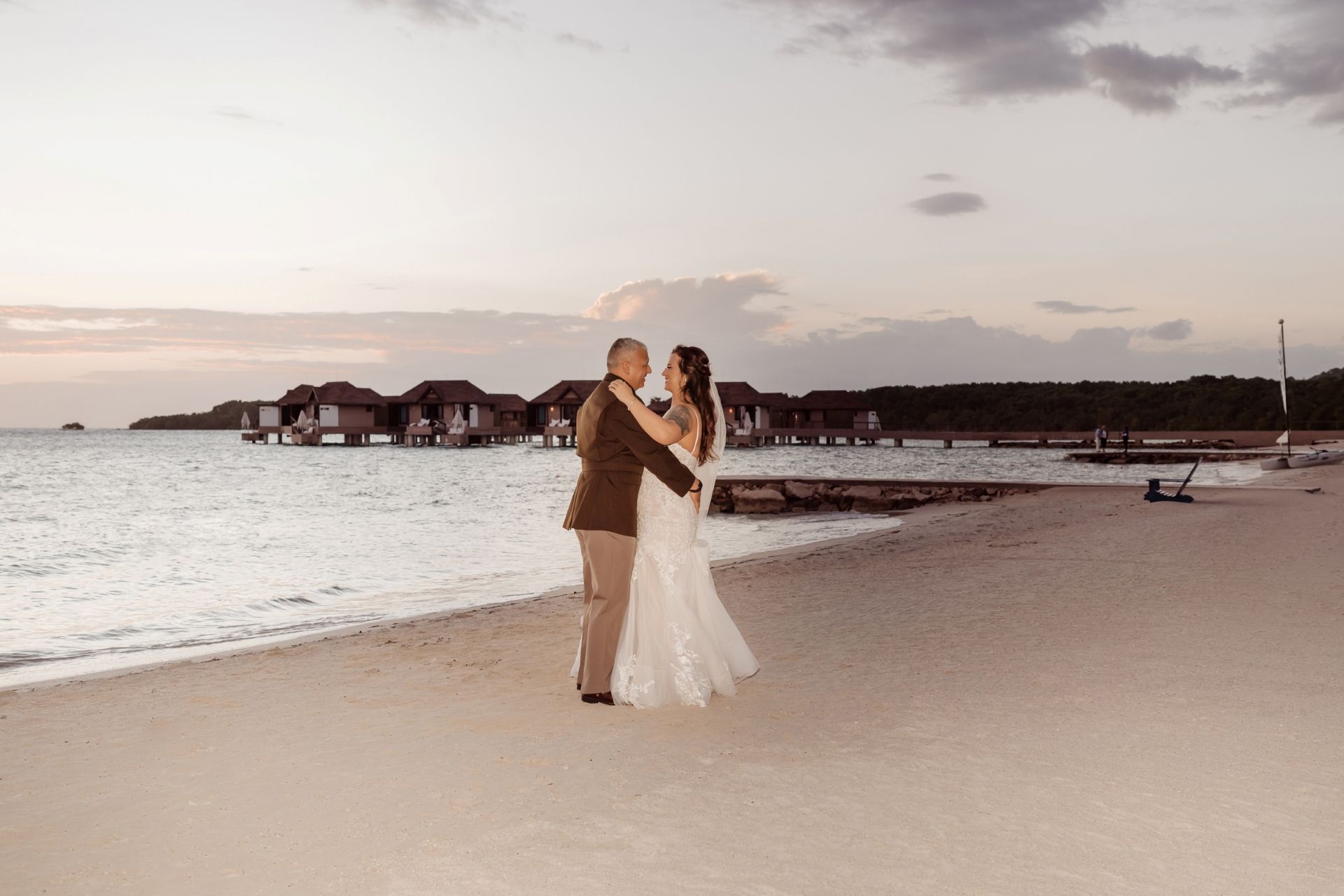 bride_and_groom_in_uniform_on_beach_shore_sunset_olga_sam