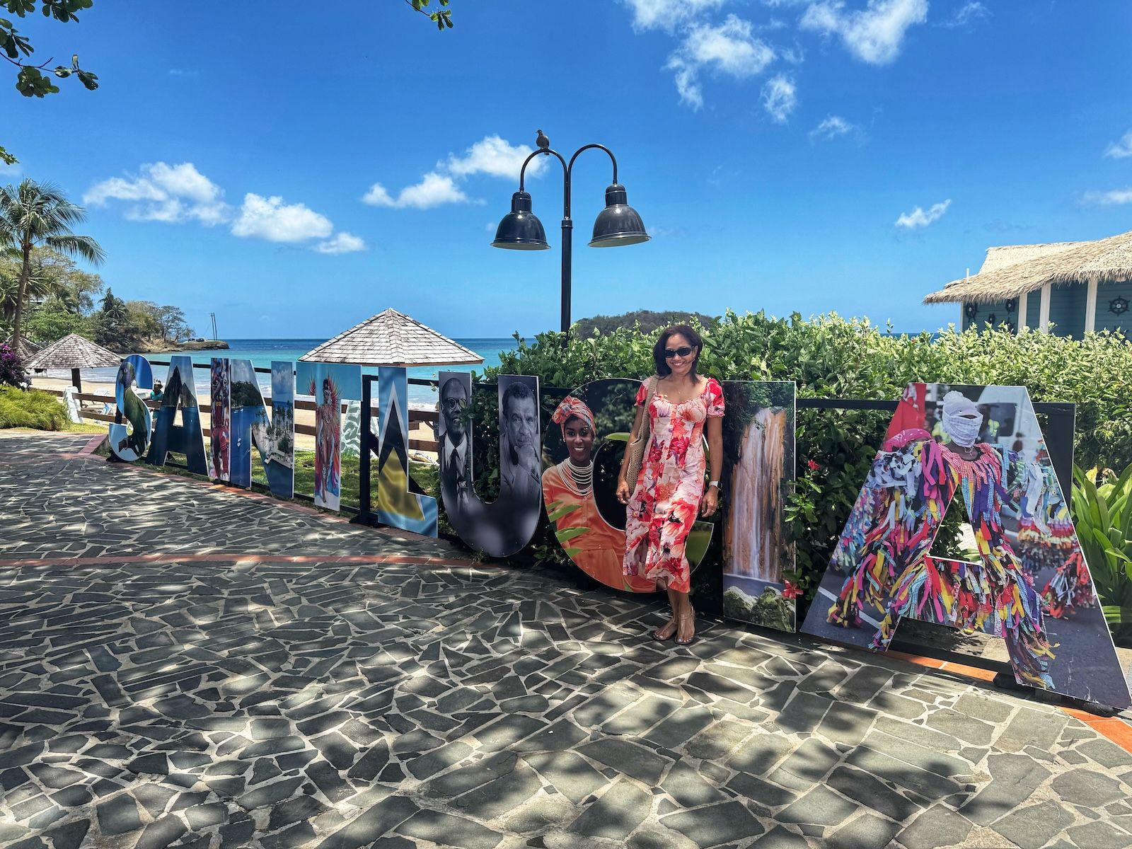 woman-standing-in-front-of-saint-lucia-sign