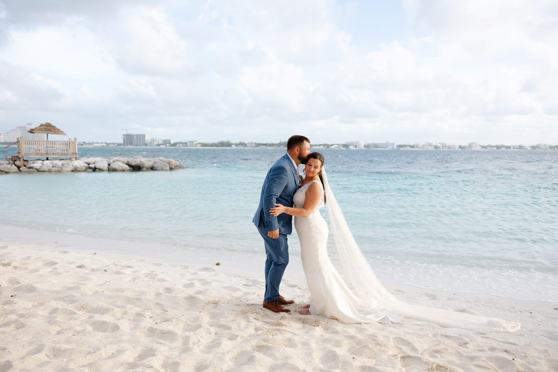 groom-kissing-bride-sandals-royal-bahamian
