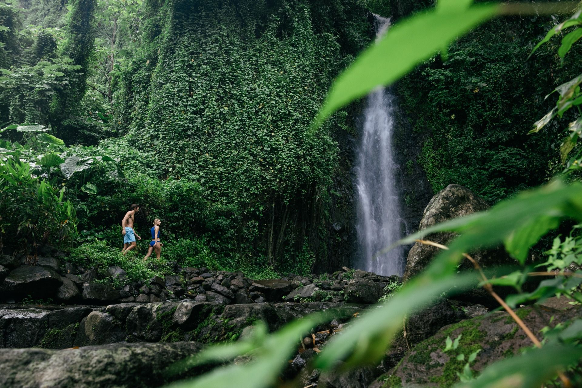 Couple running hand-in-hand along the shoreline at sunset