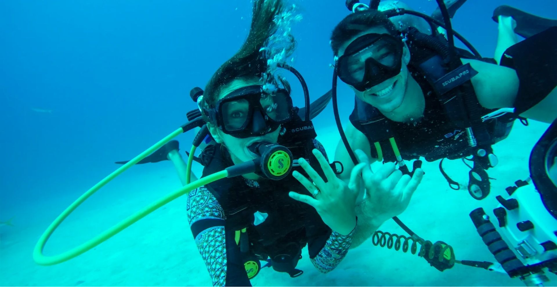 Couple scuba diving together during romantic Caribbean proposal experience