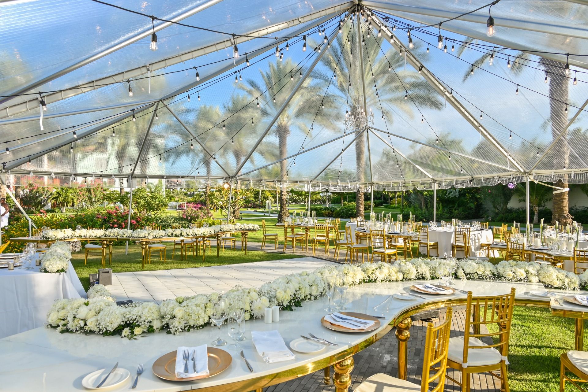 Elegant outdoor vow renewal reception setup with string lights at Sandals Royal Curaçao